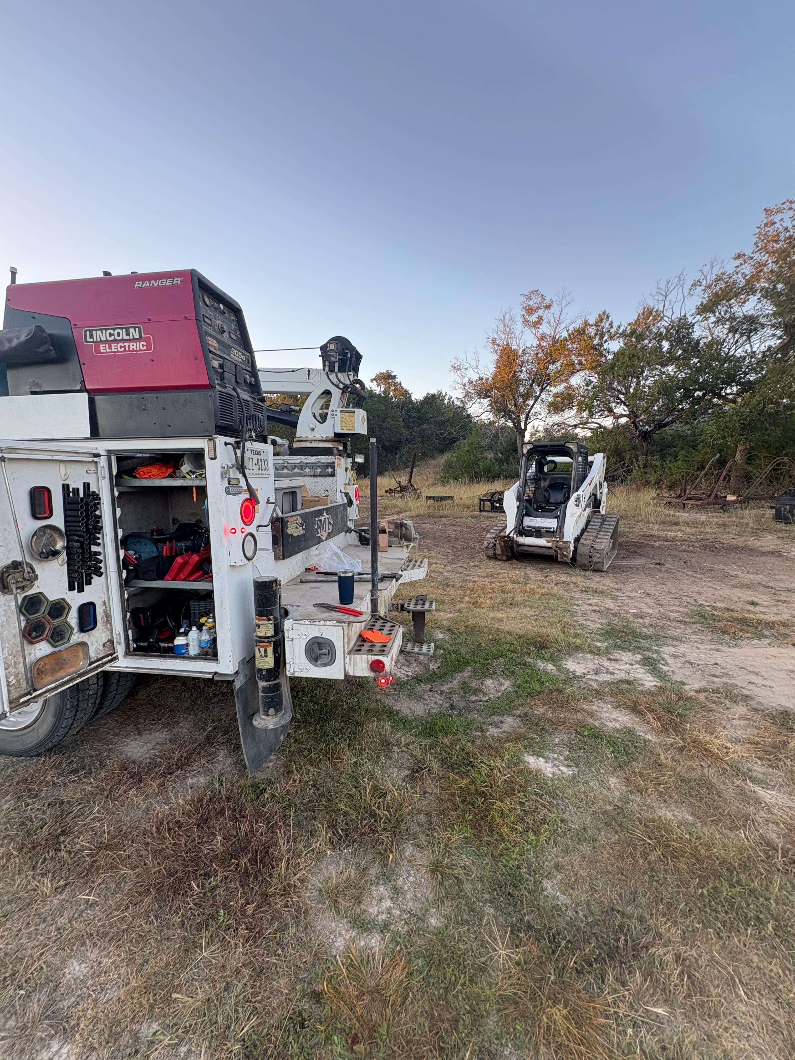 Service truck fully deployed with tool boxes and welder on-site
